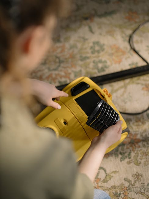 A professional cleaner from Brompton Carpet Cleaning is performing deep carpet cleaning in a residential living room. The person is dressed in full protective gear, including a white disposable covera